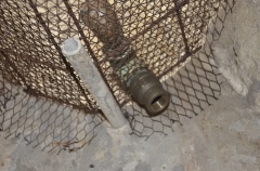 Closeup of bronze drainage for chain locker.  Fittings on ends are to keep threads clear of cement during plastering