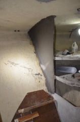 Wall freshly plastered and showing part of mold for top shelf